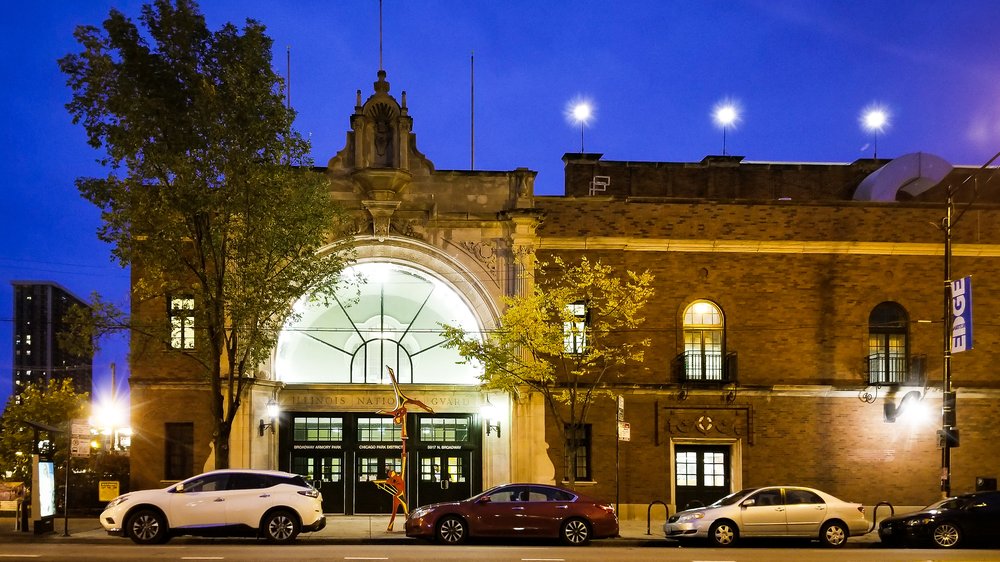 carved stone entryway is warmly lit on a summer night